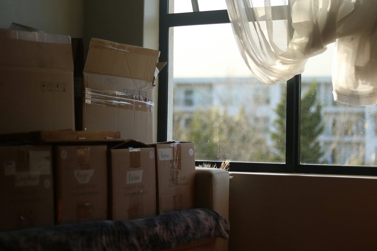 Labeled moving boxes grouped by household room.