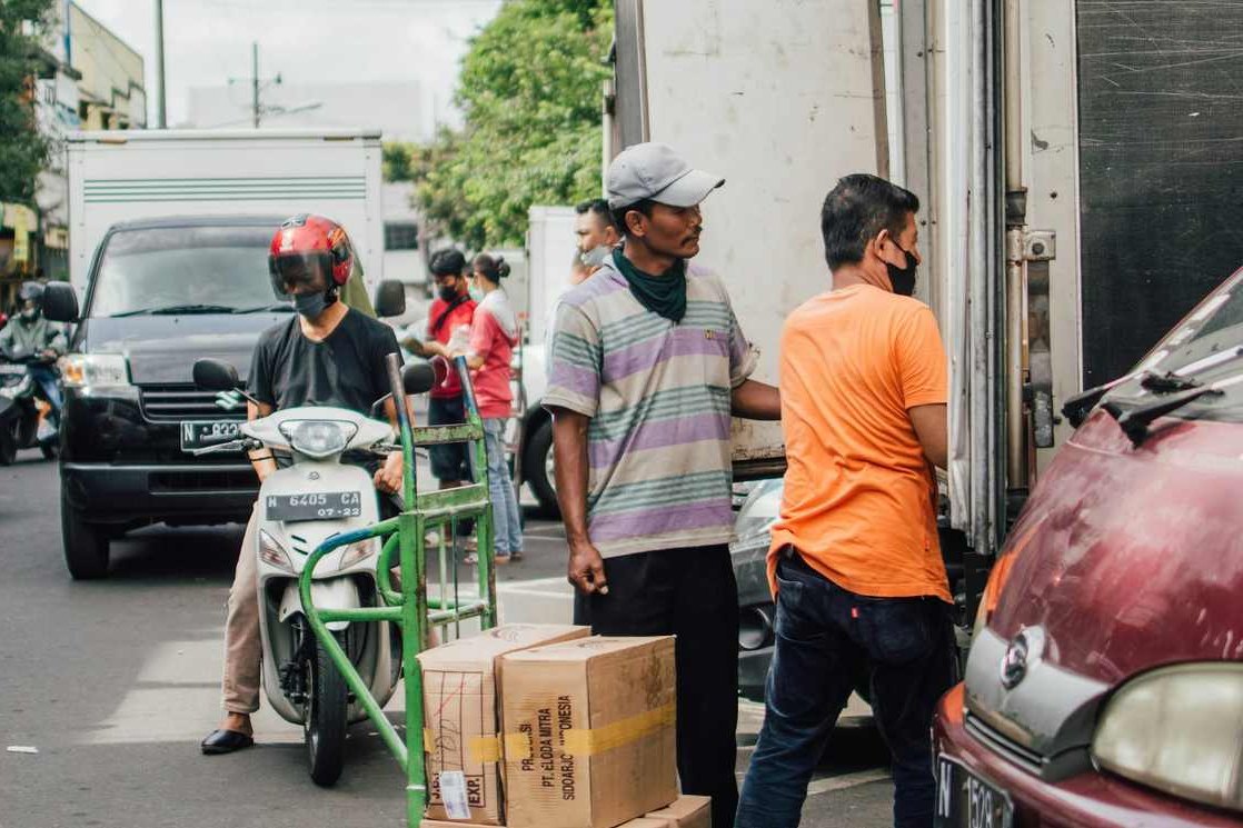 Boxes and household items being loaded into a moving van.