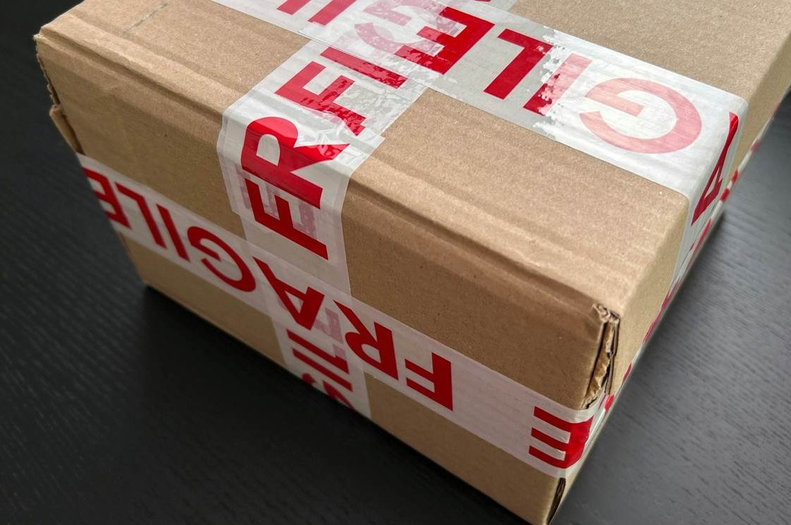 Moving checklist and room inventory clipboard beside boxes.